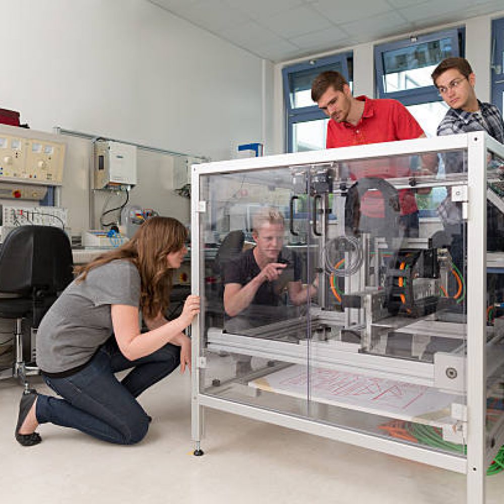 students working together in mechatronics laboratory of college