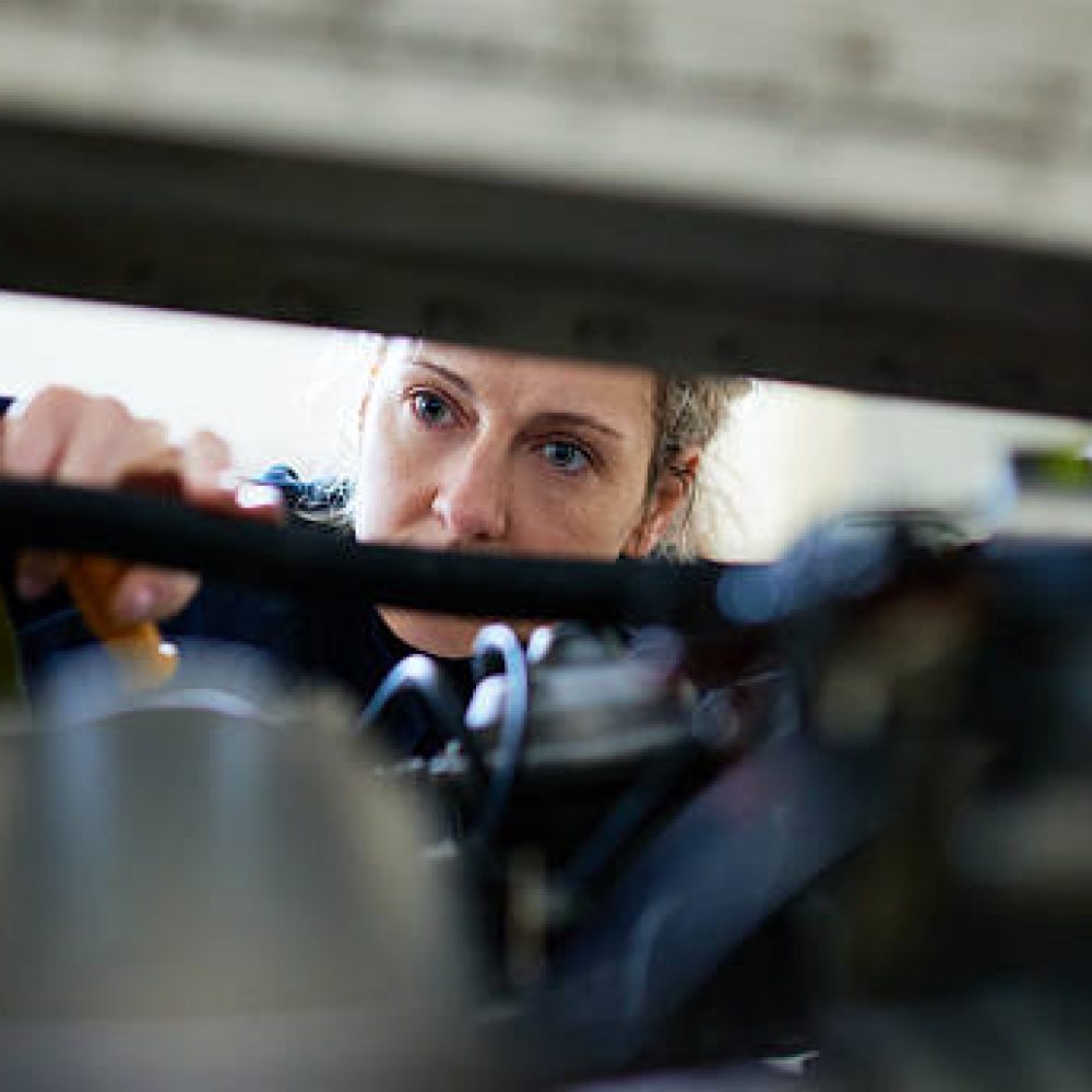 Female mechanic repairing engine of aircraft